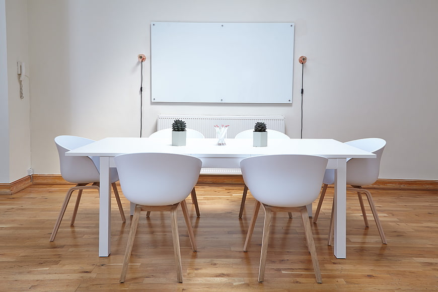 Minimalist White Dining Table With Chairs In Modern Office Room