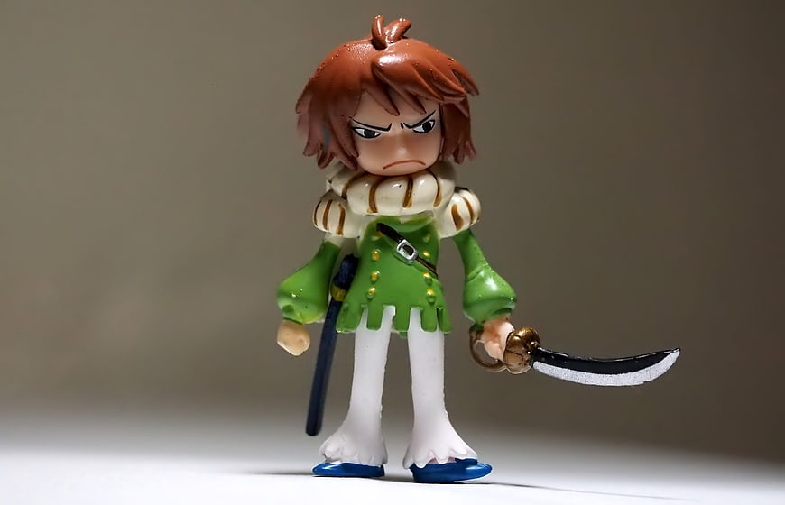 One Piece Ace Chibi Figurine Holding Cutlass Against Gray Background