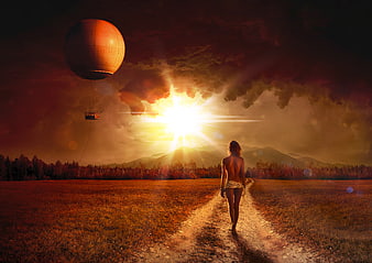 Woman Walking on Path Toward Dramatic Sunset and Hot Air Balloon