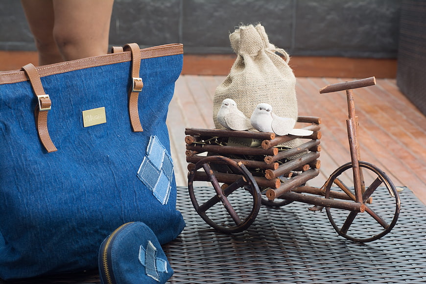 Blue denim tote bag with wooden bicycle prop