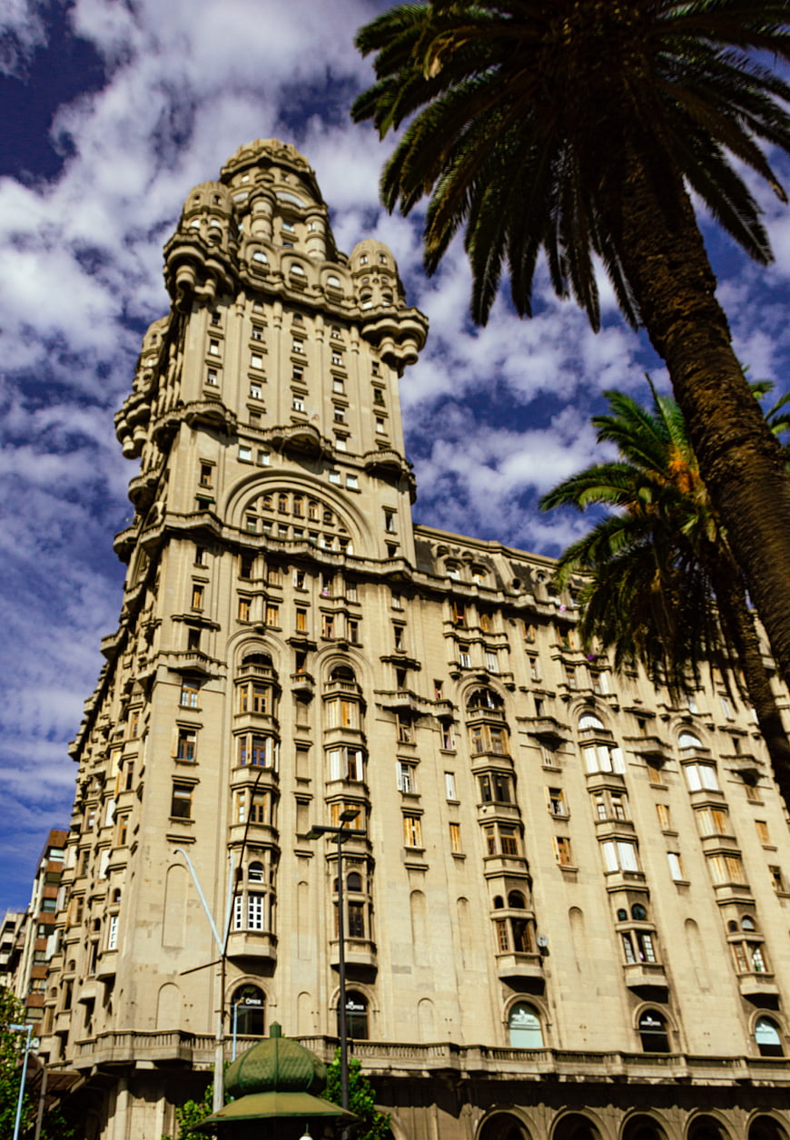 Low angle view of Palacio Salvo in Montevideo with palm trees