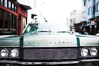 Front view of vintage green Lincoln Continental on city street