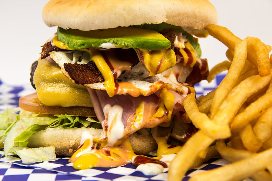 Gourmet burger with fries on checkered paper