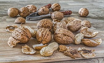 Walnuts and Nutcracker on Wooden Board