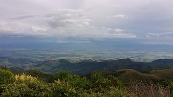 Panoramic mountain landscape with green valley and cloudy sky