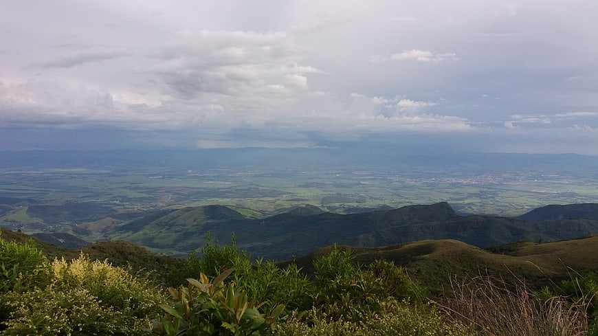 Panoramic mountain landscape with green valley and cloudy sky