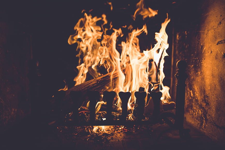 Cozy fireplace with burning wood logs and warm flames