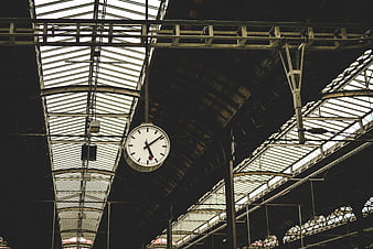 Vintage Clock Hanging in Historic Train Station Ceiling