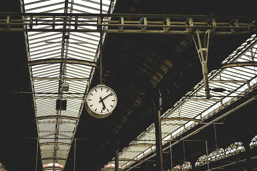 Vintage Clock Hanging in Historic Train Station Ceiling
