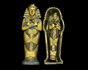 Golden Egyptian Sarcophagus and Mummy Statue Isolated on Black
