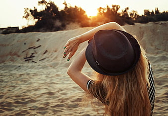 Woman in Fedora Hat on Sand Dunes at Sunset