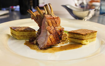 Gourmet Suckling Pig Ribs With Mashed Potato And Sauce On White Plate