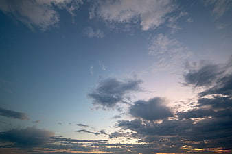 Dramatic sunset sky with scattered clouds and golden light