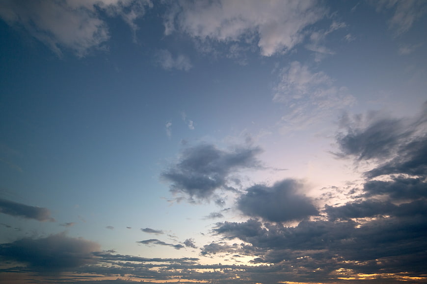 Dramatic sunset sky with scattered clouds and golden light