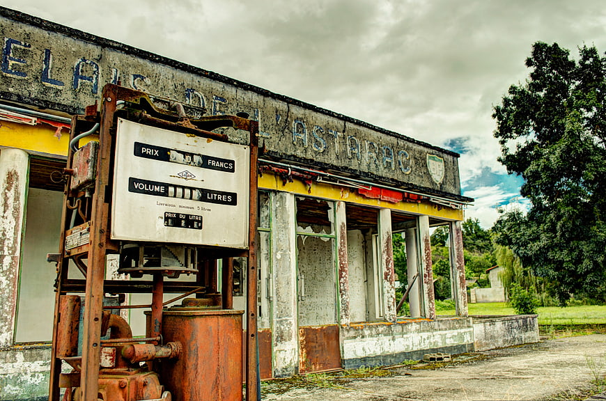 Rusty vintage gas pump at abandoned French service station