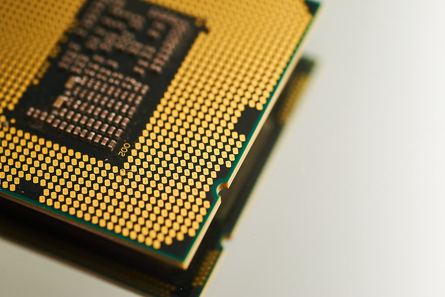 Close-up of CPU Processor Pins on White Background