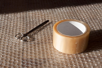 Packing Supplies: Scissors and Tape on Bubble Wrap