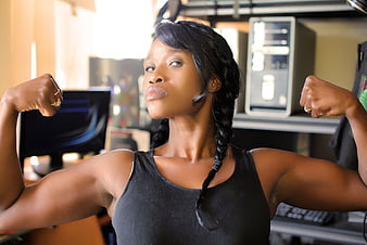 Strong Black Woman Flexing Muscles in Office