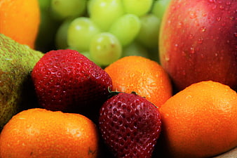 Close-up of fresh mixed fruits with water droplets