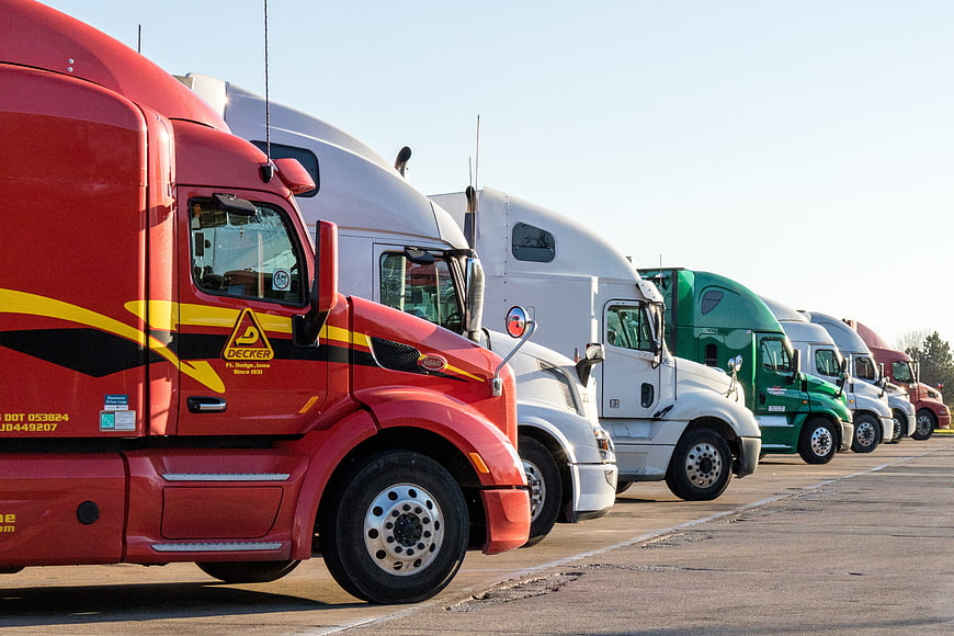 Row of colorful semi trucks parked in a lot