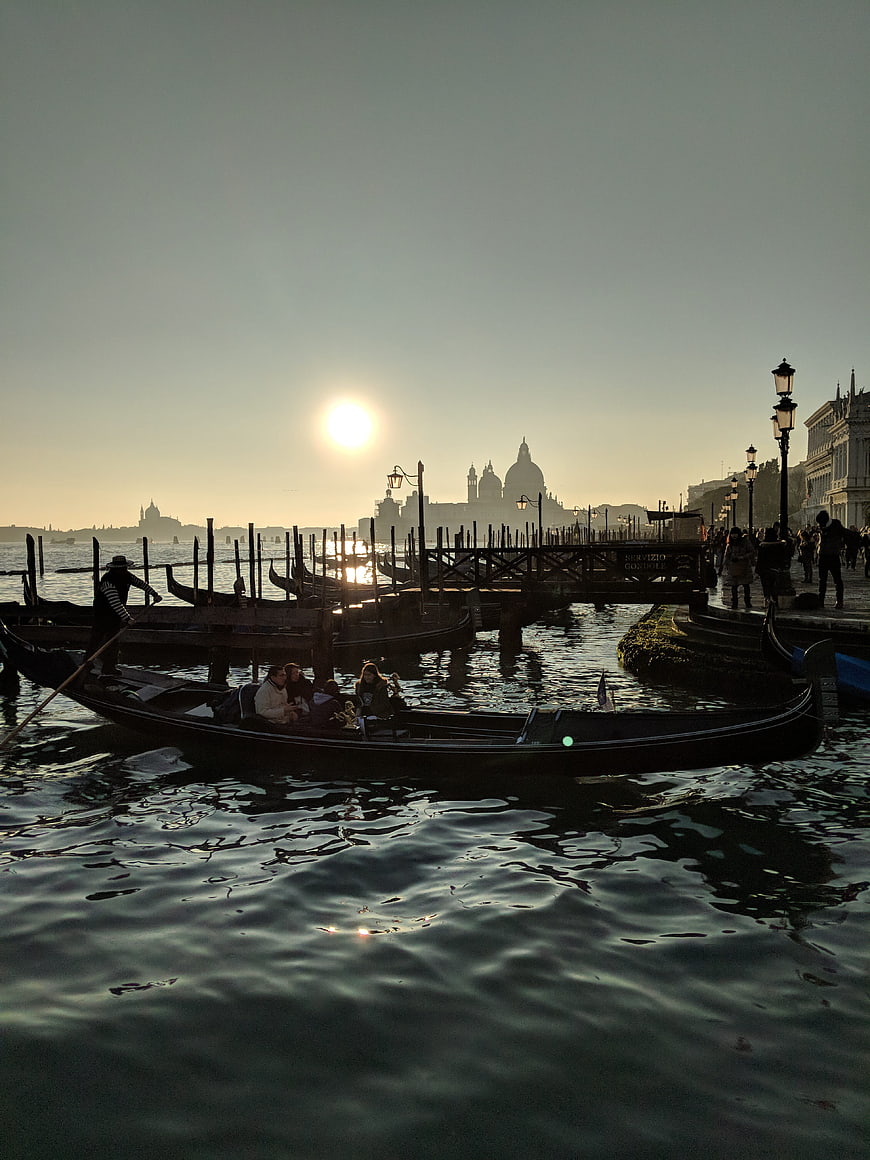 Gondola Ride in Venice at Sunset with Basilica Silhouette