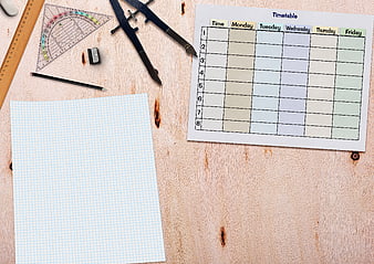 School timetable template with stationery on wooden desk