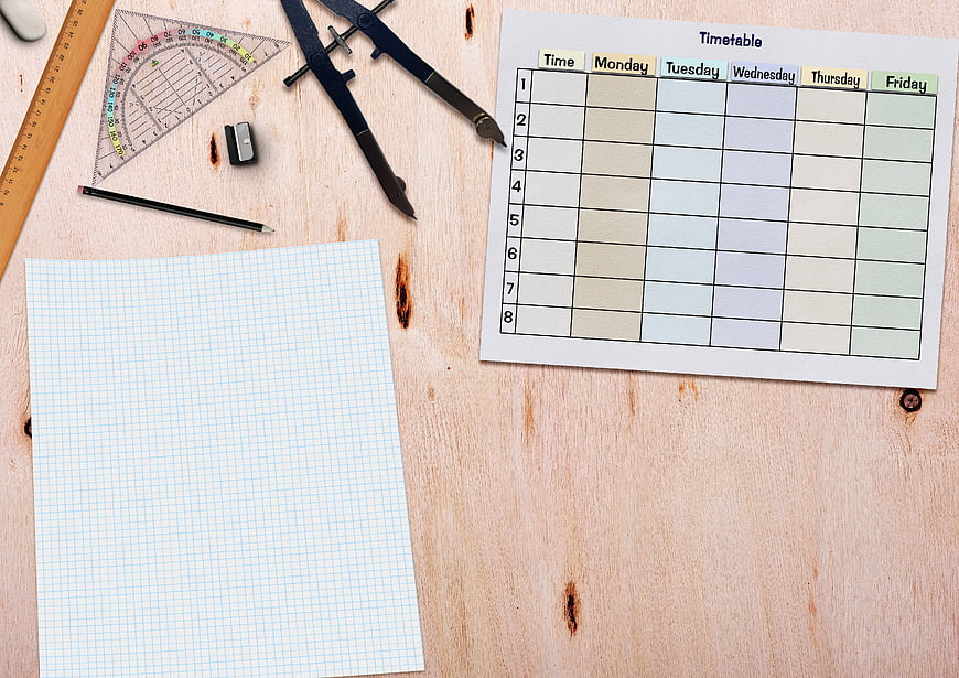 School timetable template with stationery on wooden desk