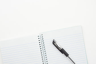 Blank spiral notebook and pen on white background
