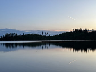 Serene Lake Reflection at Dusk with Forest Silhouette