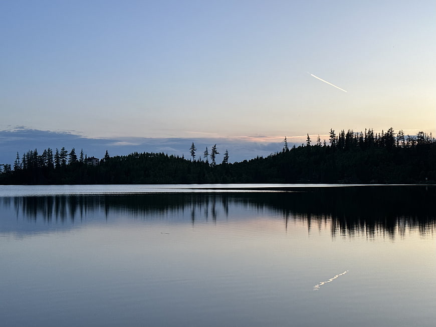 Serene Lake Reflection at Dusk with Forest Silhouette
