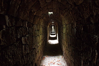 Ancient Stone Tunnel With Arched Passages And Dramatic Light