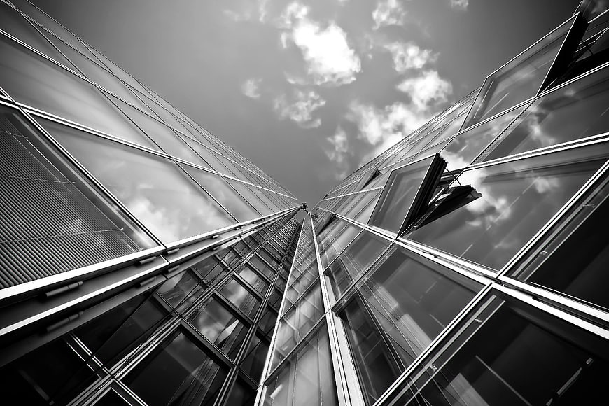 Black and white low angle view of modern glass skyscrapers