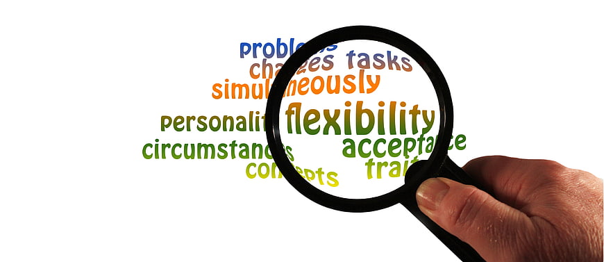 Magnifying glass focusing on flexibility word cloud concept