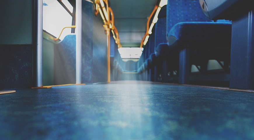 Empty Blue Bus Interior with Yellow Handrails