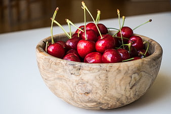 Fresh Red Cherries in a Rustic Wooden Bowl