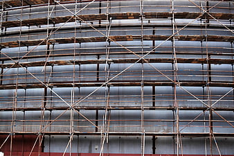 Rusty metal scaffolding structure on industrial building facade