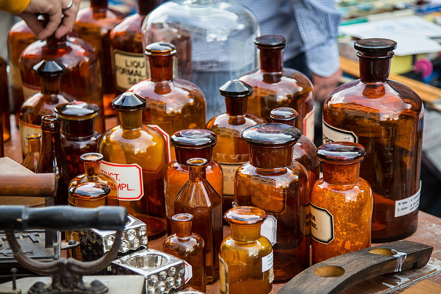 Collection of vintage amber apothecary glass bottles at flea market