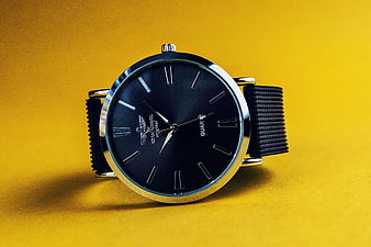 Black Analog Watch on Vibrant Yellow Background