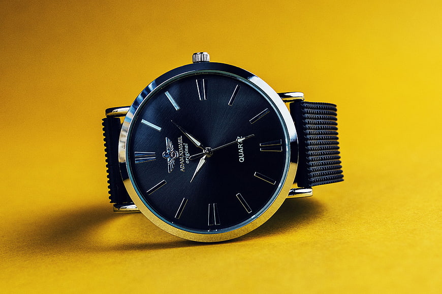 Black Analog Watch on Vibrant Yellow Background
