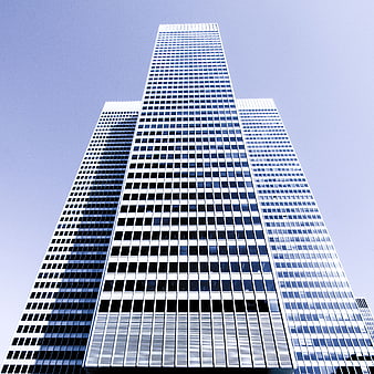 Low angle view of modern glass skyscrapers against blue sky
