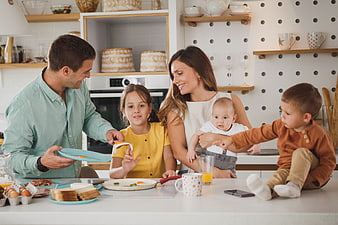 Happy family having breakfast together in modern kitchen