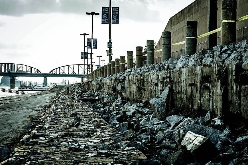 Gloomy Industrial Riverbank With Concrete Wall And Bridge