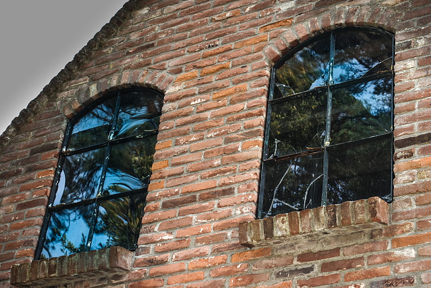 Old Brick Building with Arched Windows and Tree Reflections