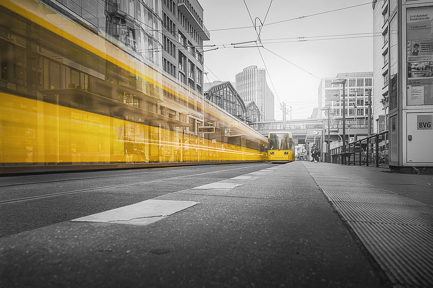 Selective Color Yellow Tram in Urban Cityscape