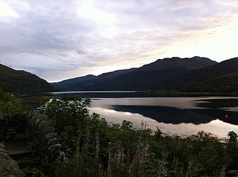 Serene Scottish Loch with Mountains and Overcast Sky