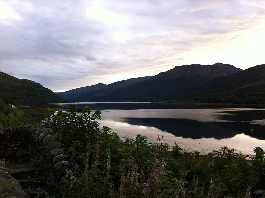 Serene Scottish Loch with Mountains and Overcast Sky