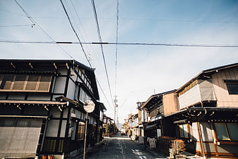Traditional Japanese Street with Wooden Buildings and Blue Sky