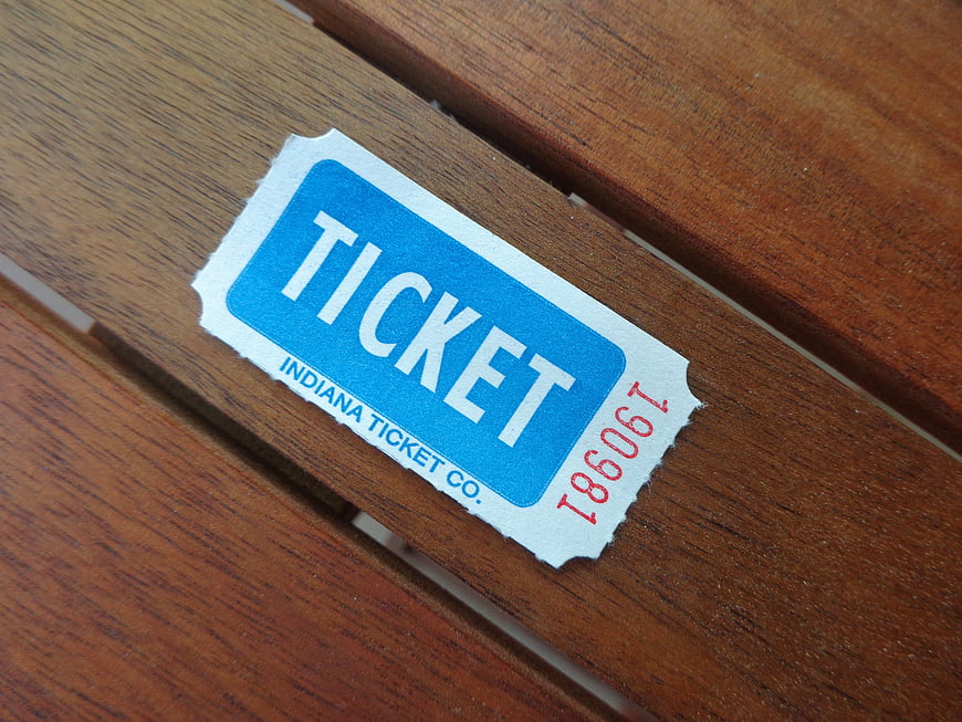 Vintage Blue Raffle Ticket on Wooden Surface
