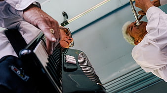 Low angle view of elderly musicians playing accordion and trumpet