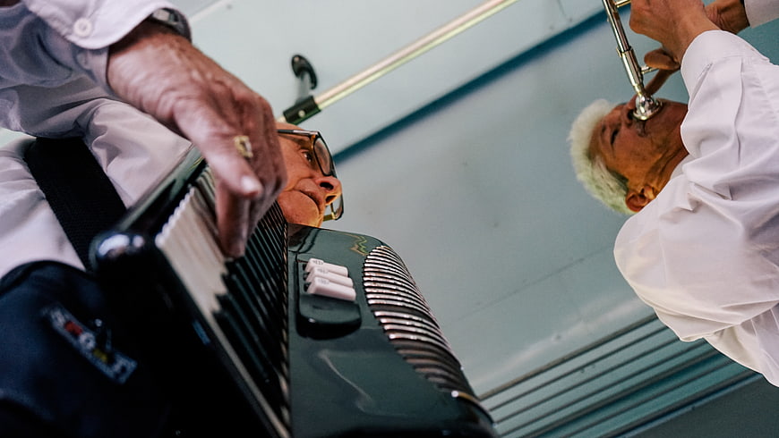 Low angle view of elderly musicians playing accordion and trumpet